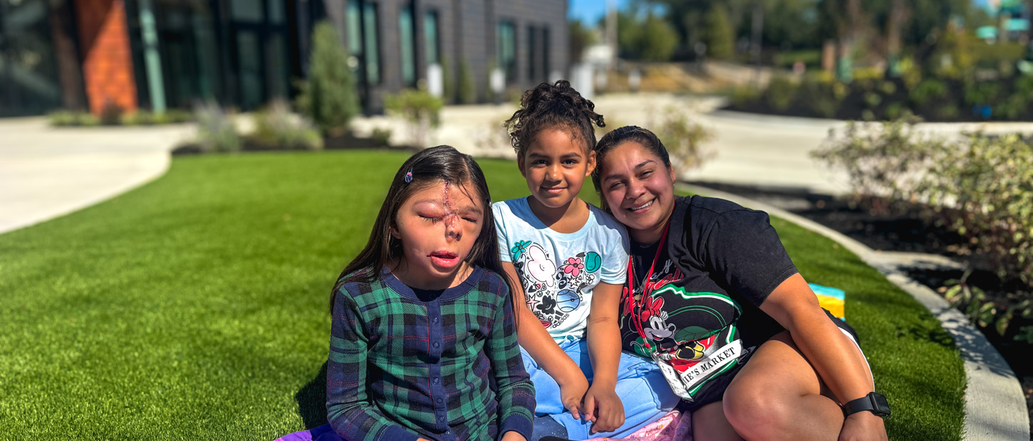 Three children sitting in front of Dayton House