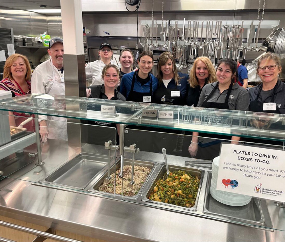 Group of Taste of Hope volunteers standing in kitchen